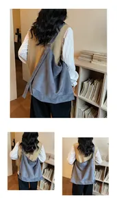 Detailed view of the blue-grey suede tote bag with a wide shoulder strap and soft texture