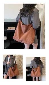 Detail view of large brown suede tote bag showing hobo style and matte texture