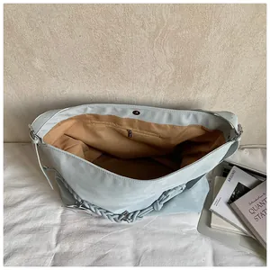 Interior detail of large tote bag showing woven handle and magnetic snap closure