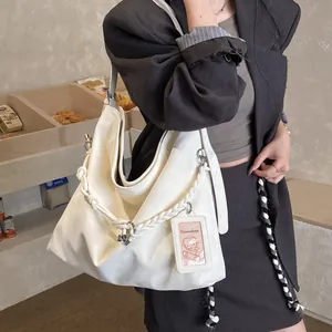 Chic beige oversized hobo shoulder bag with stylish woven rope detail for casual daily use