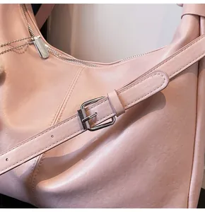Detail of adjustable silver buckle on pink leather strap of the fashion tote bag