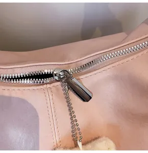 Detail of silver zipper and bead chain on premium pale pink textured tote bag