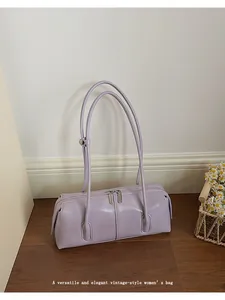 Detail shot of a lavender baguette bag with sleek finish and silver metal zipper