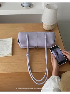 Chic lavender baguette bag with double zipper on wooden table for daily use