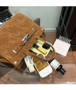 Detail view of caramel suede handbag showing high capacity for phone and essentials