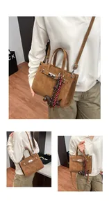 Detail of vintage brown crossbody bag with metal clasp and small dog charm accessory