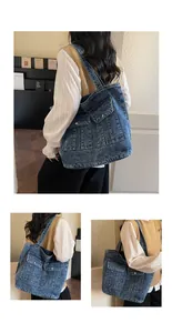 Detailed close-up showing dual pockets and metal buttons on a vintage denim tote bag