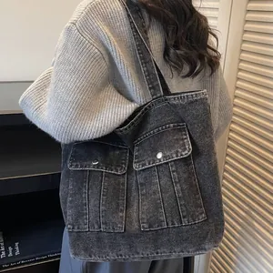 Vintage dark gray denim tote bag with large double pockets and wide shoulder strap