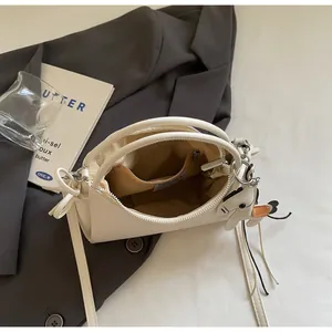 Interior view of cream soft leather bag showing the inner pocket and smooth zipper