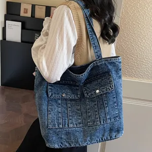 Retro vintage washed denim tote bag with large capacity and front pockets shown on model