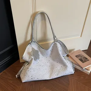 Sac fourre-tout blanc avec broderie d'étoiles argentées et anses métalliques