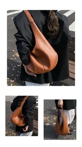 Close-up of brown pebble grain leather hobo bag with seamless wide shoulder strap