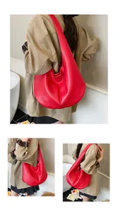 Detailed macro view of a red large-capacity hobo bag with lychee grain leather texture