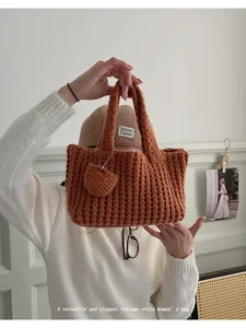 Detalle de bolso tote tejido a mano en marrón oscuro con textura y colgante de corazón