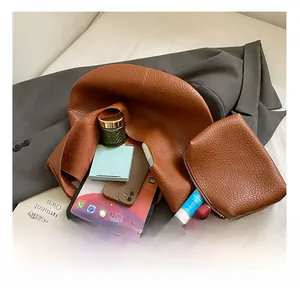 Detail showing spacious interior of brown lychee texture tote bag with a matching pouch