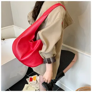 Detail of red lychee textured shoulder tote bag showing large capacity and minimalist style