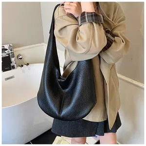 Detailed view of spacious black lychee pattern leather tote bag for daily commute