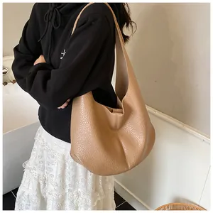 Close-up of khaki pebbled leather hobo bag with wide shoulder strap and spacious interior