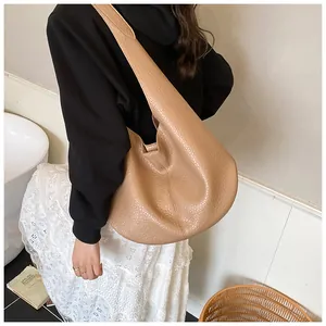 Detail of light brown hobo bag showing high-quality pebbled faux leather texture and seams