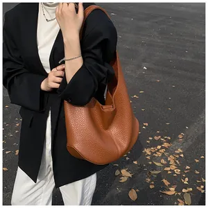 Side view of a large brown hobo bag showing pebbled leather texture and ample storage space