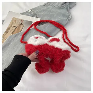 Detail of red and white faux fur crossbody bag with thick woven shoulder strap