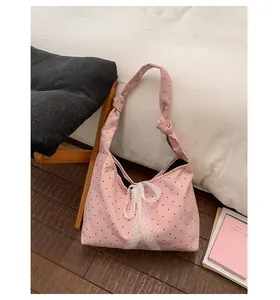 Pink polka dot canvas tote bag featuring lace bow detail and stylish knotted shoulder strap