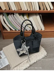Detail of vintage navy plaid denim tote bag with knotted handles and star charm