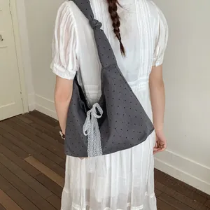 Large capacity grey canvas tote bag with black polka dots and a white lace bow detail