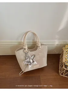 Close-up of beige checkered bucket bag featuring canvas texture and silver star charm