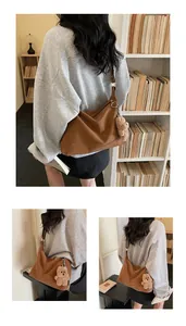 Detail view of brown matte PU leather tote bag with a cute plush bear pendant accessory