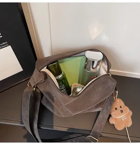 Top-down view of spacious dark brown matte tote interior with wide strap and teddy charm