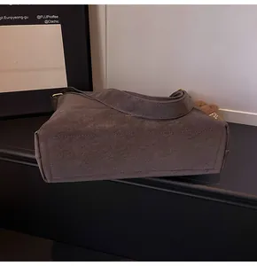 Detailed close-up of dark brown matte texture tote bag with a cute plush bear accessory