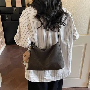 Minimalist matte leather tote bag in dark grey with a cute plush bear charm on strap