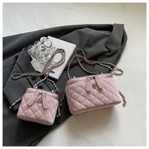 Detail of pink quilted box bags in two sizes with elegant metal flower zippers