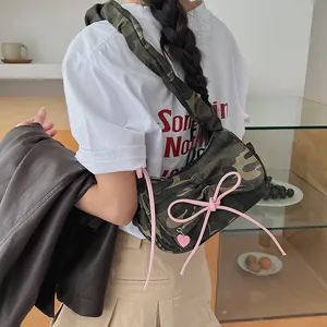 Camouflage baguette bag with pink bows and heart pendant, stylish shoulder strap design