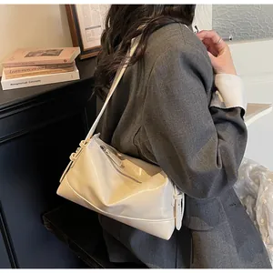 Detailed close-up of creamy white PU leather texture and stitching on the pillow bag