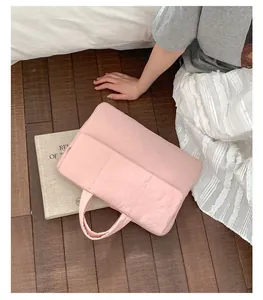 Close-up of pink laptop sleeve with two front pockets and minimalist carry handles
