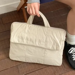 Minimalist cream quilted laptop handbag with top handle and front flap pocket for women