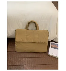 Quilted khaki laptop handbag with top handles and front flap pocket for daily commute