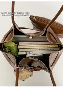 Spacious tote bag interior showing capacity with a removable zipper pouch and charm
