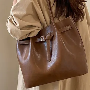 Brown large capacity leather tote bag with decorative buckle for daily office commute