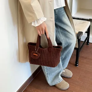 Handmade chunky knit handbag in dark brown with heart charm and handmade leather label