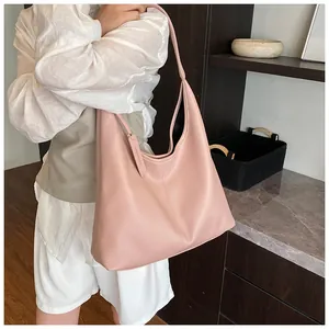 Détail du sac cabas rose poudré montrant la texture grainée et les coutures fines