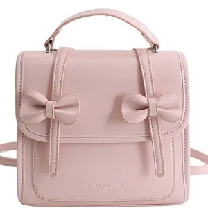 Sac à dos chic en similicuir rose pour femme avec deux nœuds et une poignée robuste