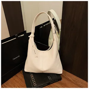 Détail du cuir grainé litchi sur un grand sac hobo fourre-tout de couleur crème chic