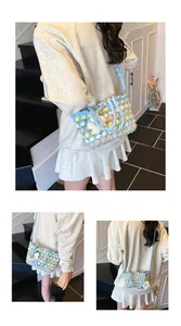 Detailed close-up of handmade crochet floral shoulder bag with colorful 3D flower patterns