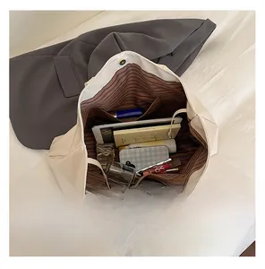 Top-down macro view of spacious tote bag interior showing striped lining and pockets