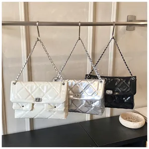 Quilted crossbody bags in cream, silver, and black with metal turn-lock and chain strap