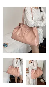 Detail showing the glossy pink leather texture and spacious design of the tote bag