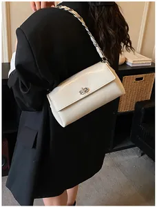 Vue détaillée du sac sous le bras blanc crème avec chaîne argentée porté par un mannequin